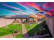 An expansive backyard features green grass, mature trees, and outdoor living spaces at 16671 W Mckinley St, Goodyear, AZ 85338
