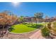 Large artificial turf backyard with covered seating area and views of the refreshing pool at 16671 W Mckinley St, Goodyear, AZ 85338