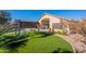 Sprawling backyard with a covered pergola, artificial turf, and desert landscaping for outdoor enjoyment at 16671 W Mckinley St, Goodyear, AZ 85338
