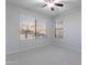 Bedroom with neutral walls, carpet floors, ceiling fan, and a window offering views of the neighborhood at 16671 W Mckinley St, Goodyear, AZ 85338