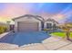 Charming single-story home with a two car garage and a well-manicured lawn at 16671 W Mckinley St, Goodyear, AZ 85338