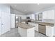Updated kitchen features white cabinets, stainless steel appliances and a center island at 16671 W Mckinley St, Goodyear, AZ 85338