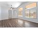 Spacious living room with high ceilings, lots of windows, wood floors, and arched doorways at 16671 W Mckinley St, Goodyear, AZ 85338