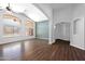 Bright living room with high ceilings, lots of windows, wood floors, and an arched doorway at 16671 W Mckinley St, Goodyear, AZ 85338