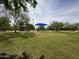 Expansive community park with grassy lawns, walking paths, a playground, and picnic areas at 16671 W Mckinley St, Goodyear, AZ 85338
