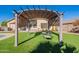Relax under the backyard pergola with views of lush artificial turf and desert landscaping at 16671 W Mckinley St, Goodyear, AZ 85338