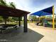 Community playground featuring a shaded picnic area and play structure with slide and climbing wall at 16671 W Mckinley St, Goodyear, AZ 85338