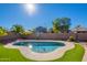 Backyard pool with surrounding green turf and privacy fence with nearby homes at 16671 W Mckinley St, Goodyear, AZ 85338