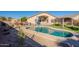 Inviting kidney-shaped pool surrounded by an expansive backyard, perfect for outdoor living and entertaining at 16671 W Mckinley St, Goodyear, AZ 85338