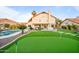 Expansive backyard with in-ground pool, putting green, and entertainment space at 17614 N 56Th Way, Scottsdale, AZ 85254