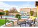 Backyard oasis with a sparkling pool, lounge chairs, and a stylish fire pit area at 17614 N 56Th Way, Scottsdale, AZ 85254