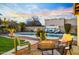Inviting backyard oasis with pool, fire pit, lounge chairs, desert landscape, and outdoor seating under string lights at 17614 N 56Th Way, Scottsdale, AZ 85254