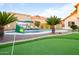 Beautiful backyard featuring a pristine pool, putting green, and lush landscaping at 17614 N 56Th Way, Scottsdale, AZ 85254