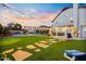 Expansive backyard featuring a pool, putting green, and charming string lights at dusk at 17614 N 56Th Way, Scottsdale, AZ 85254