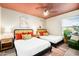 Cozy bedroom with two beds, colorful decor, and a ceiling fan for added comfort at 17614 N 56Th Way, Scottsdale, AZ 85254