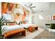 Stylish bedroom with ensuite bath, painted accent wall, two beds, and bench seats at 17614 N 56Th Way, Scottsdale, AZ 85254