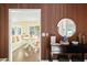 Stylish entryway with wood accent wall, modern mirror, and glimpse into the dining room at 17614 N 56Th Way, Scottsdale, AZ 85254