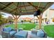 Outdoor gazebo featuring TV and seating, set in a backyard with a putting green and pool at 17614 N 56Th Way, Scottsdale, AZ 85254