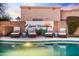 Stylish pool with lounge chairs, set against a creative 'Desert Wanderer' accent wall at 17614 N 56Th Way, Scottsdale, AZ 85254
