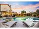 Scenic view of a backyard pool with lounge chairs and lush landscaping at sunset at 17614 N 56Th Way, Scottsdale, AZ 85254