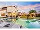Beautiful backyard pool with lounge chairs and a view of the covered patio and putting green at 17614 N 56Th Way, Scottsdale, AZ 85254
