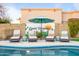 Relaxing poolside seating area with stylish lounge chairs and colorful accent wall at 17614 N 56Th Way, Scottsdale, AZ 85254