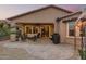 Beautiful backyard patio featuring a sitting area, barbeque, and covered patio access to the home at 17938 W Cedarwood Ln, Goodyear, AZ 85338