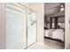 Modern bathroom featuring a glass-enclosed shower and a view into the bedroom at 17938 W Cedarwood Ln, Goodyear, AZ 85338