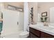 Bathroom featuring a shower-tub combo with white tile surround and brushed nickel fixtures at 17938 W Cedarwood Ln, Goodyear, AZ 85338