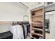 Organized walk-in closet with shelves, hanging racks, and designated space for clothing and shoes at 17938 W Cedarwood Ln, Goodyear, AZ 85338