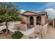 Charming single-story home featuring desert landscaping, a covered porch, and a two-car garage at 17938 W Cedarwood Ln, Goodyear, AZ 85338