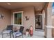 Inviting front porch with seating area, decorative lizard accent, and secure front door at 17938 W Cedarwood Ln, Goodyear, AZ 85338