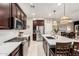 Modern kitchen with stainless steel appliances, white countertops, and dark wood cabinets at 17938 W Cedarwood Ln, Goodyear, AZ 85338
