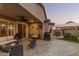 Covered patio featuring stylish outdoor furniture, and access to a landscaped backyard with a gazebo at 17938 W Cedarwood Ln, Goodyear, AZ 85338
