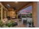 Covered patio featuring stylish outdoor furniture, a ceiling fan, and access to a landscaped backyard at 17938 W Cedarwood Ln, Goodyear, AZ 85338