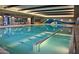 Inviting indoor community pool with a soothing design, ideal for year-round enjoyment and relaxation at 17938 W Cedarwood Ln, Goodyear, AZ 85338