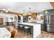 Spacious kitchen with seating at the large island, stainless steel appliances and wood accents at 1825 N Granite Reef Rd, Scottsdale, AZ 85257
