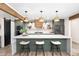 Beautiful kitchen with sage cabinets, an island with a quartz countertop and pendant lights at 1825 N Granite Reef Rd, Scottsdale, AZ 85257
