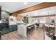 Open-concept kitchen boasts wooden beams, oversized island with seating, and modern appliances at 1825 N Granite Reef Rd, Scottsdale, AZ 85257