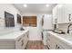 Bright laundry room featuring stacked washer and dryer, storage, and sleek countertops at 1825 N Granite Reef Rd, Scottsdale, AZ 85257