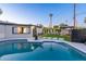 Backyard pool and patio area with outdoor seating and manicured lawn at 1825 N Granite Reef Rd, Scottsdale, AZ 85257