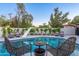 Backyard pool with a slide, mature trees, a privacy fence and outdoor seating at 1825 N Granite Reef Rd, Scottsdale, AZ 85257