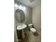 Half bathroom featuring a pedestal sink, toilet, and tile flooring at 1920 E Bell Rd # 1188, Phoenix, AZ 85022