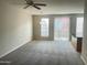 Spacious living room with carpet flooring, ceiling fan, and natural light at 1920 E Bell Rd # 1188, Phoenix, AZ 85022