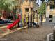 Community playground for children with colorful play structures and a comfortable wood chip ground cover at 1920 E Bell Rd # 1188, Phoenix, AZ 85022