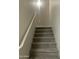 Carpeted stairway with handrail leading to the upper level of the home at 1920 E Bell Rd # 1188, Phoenix, AZ 85022