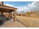 Backyard with covered patio including dining table, grill, and views of the rear block fence at 20916 E Via De Arboles --, Queen Creek, AZ 85142