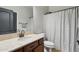 Neutral bathroom featuring a white basin sink on a brown cabinet and a shower with grey and white curtain at 20916 E Via De Arboles --, Queen Creek, AZ 85142