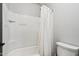 Close up of the bathtub and shower in the bathroom featuring white tiling and a shower curtain at 20916 E Via De Arboles --, Queen Creek, AZ 85142