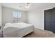 Bedroom with window, ceiling fan, carpet, and a black-trimmed door at 20916 E Via De Arboles --, Queen Creek, AZ 85142